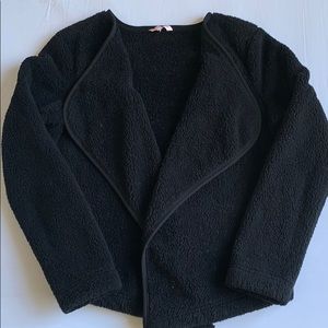 Black fuzzy sweater.